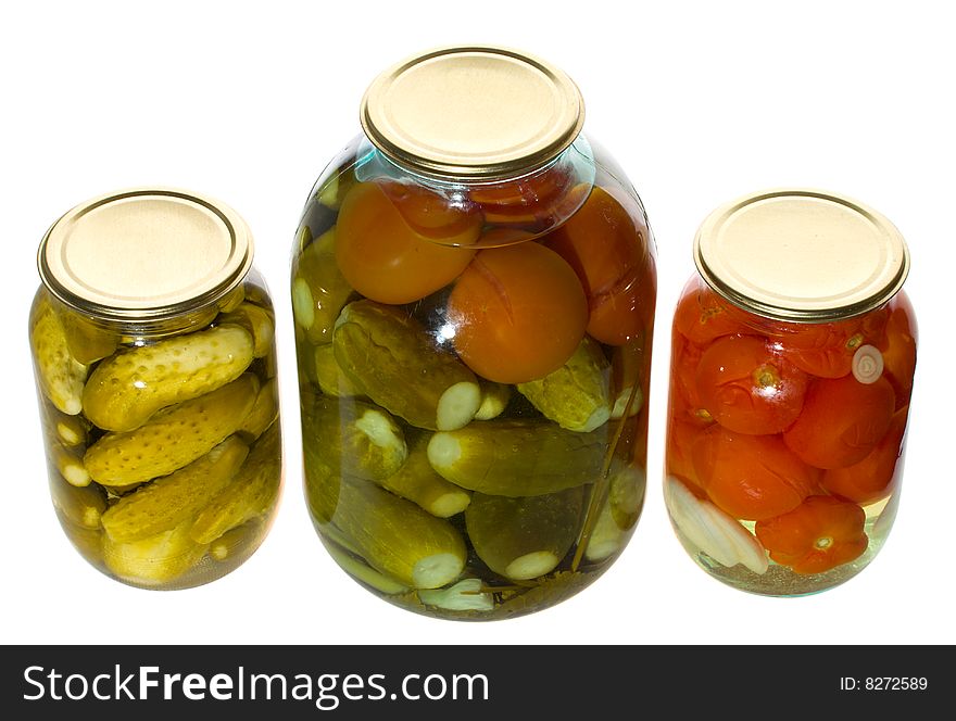 One big and two small jars with vegetables, isolated on white