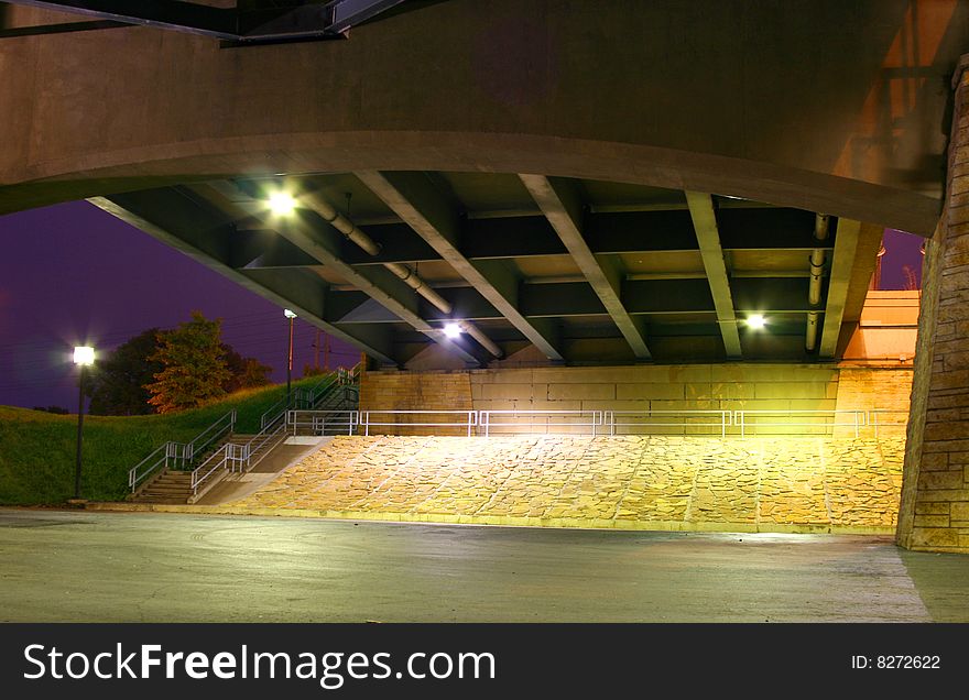 Concrete support underneath a bridge at night. Concrete support underneath a bridge at night.