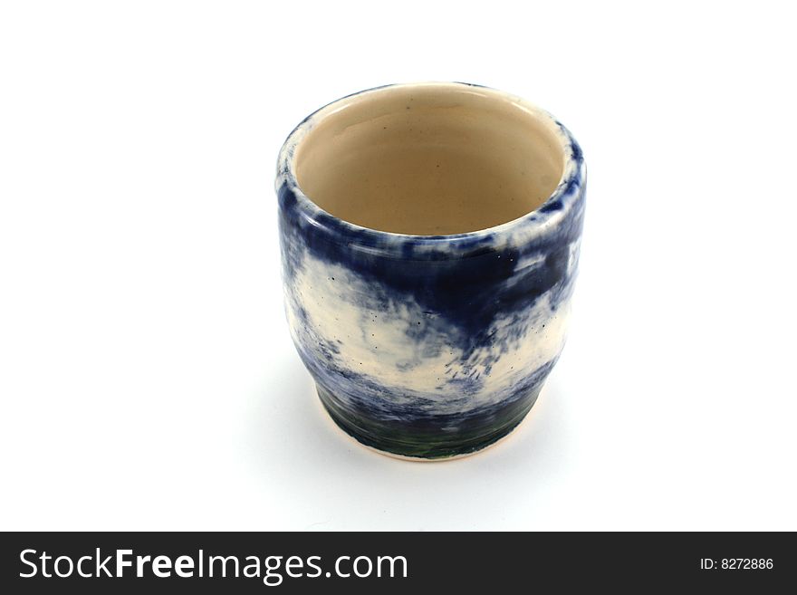 Homemade blue and white pottery bowl isolated on white.