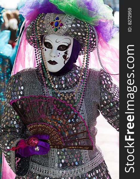 Silver costume with colourful sequins at the Venice Carnival. Silver costume with colourful sequins at the Venice Carnival