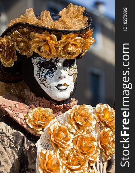 Gold costume with golden roses at the Venice Carnival. Gold costume with golden roses at the Venice Carnival
