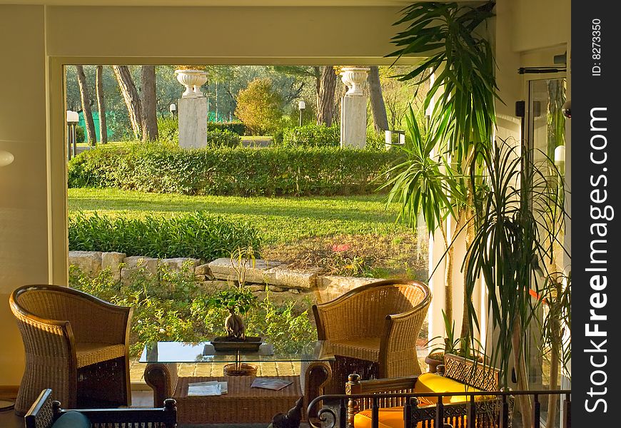 View of italian resort interior with windows and chairs