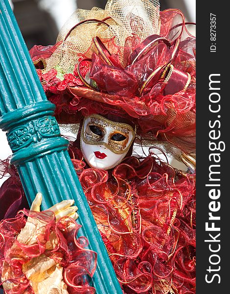 Red and gold costume at the Venice Carnival. Red and gold costume at the Venice Carnival