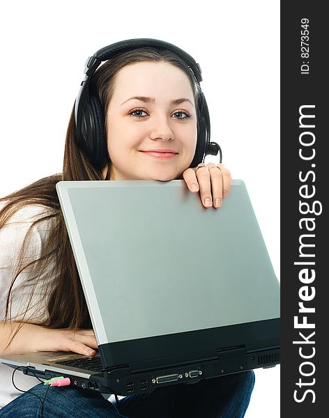 Happy young woman wearing earphones with a laptop. Happy young woman wearing earphones with a laptop