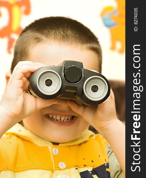 A boy looking through a binocular. A boy looking through a binocular