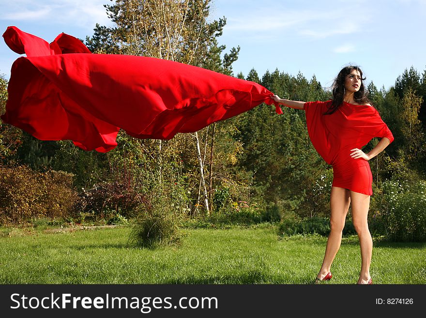Girl in red dress with flapping fabric. Girl in red dress with flapping fabric