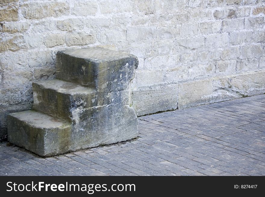 Stone Mounting Block next to a stone wall