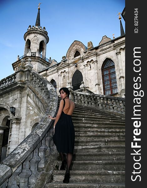 Brunette beside  castle