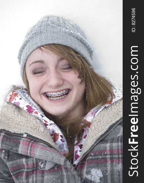 Teen girl laughing in the snow