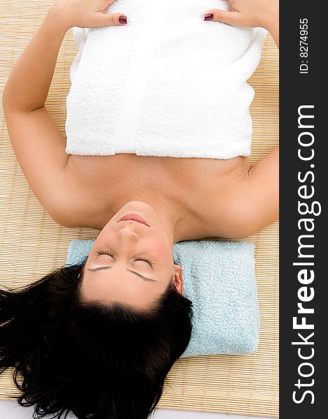 Top view of smiling young woman scrubbing her body against white background. Top view of smiling young woman scrubbing her body against white background