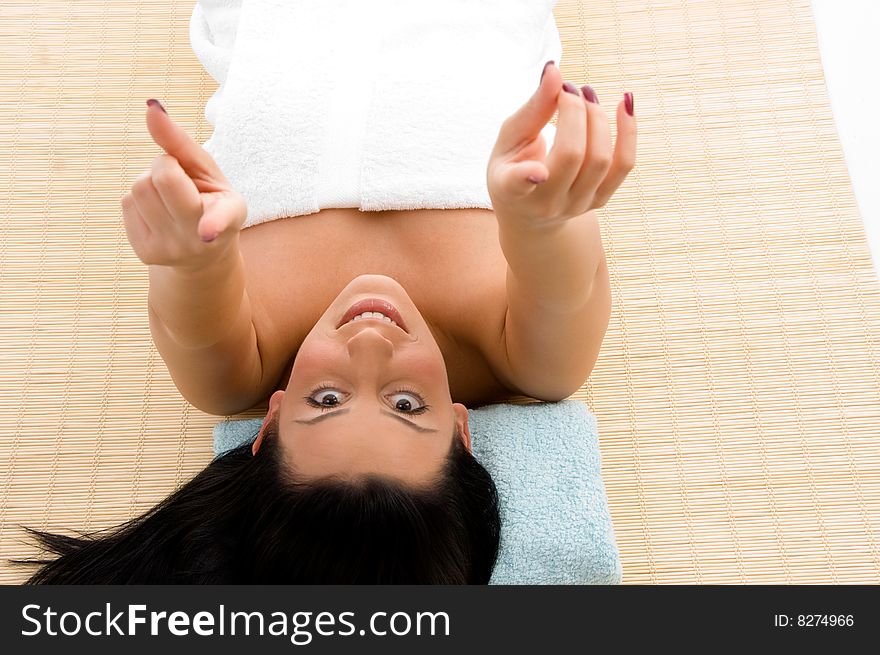 Top view of smiling young woman scrubbing her body against white background. Top view of smiling young woman scrubbing her body against white background