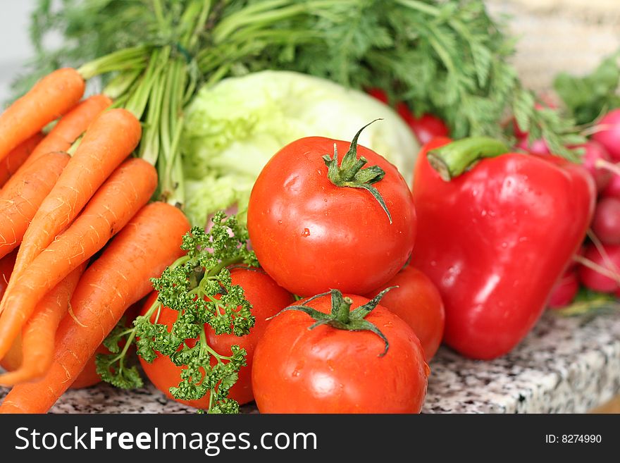 Different vegetables on the table in the kitchen. Different vegetables on the table in the kitchen