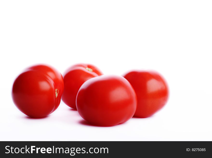 Four red delicious tomatos on white. Four red delicious tomatos on white