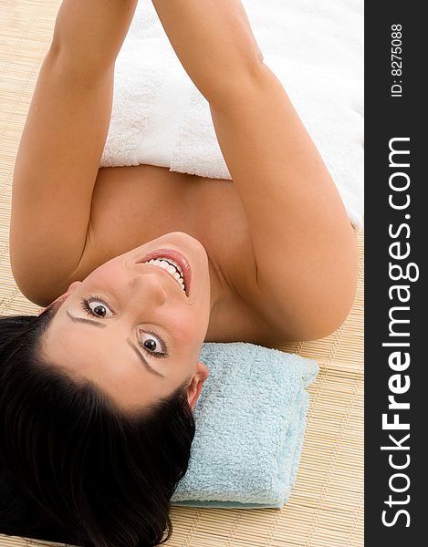 Top view of smiling young woman scrubbing her body against white background. Top view of smiling young woman scrubbing her body against white background