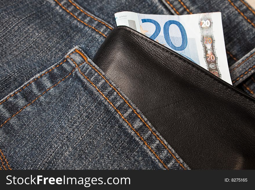 Denim jeans with a wallet and a twenty euro note