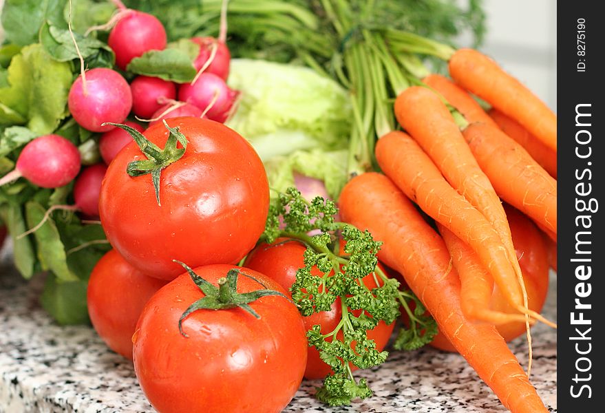 Different vegetables on the table in the kitchen. Different vegetables on the table in the kitchen