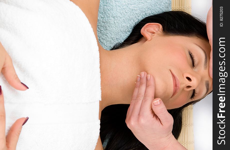 Top view of smiling young woman scrubbing her body against white background. Top view of smiling young woman scrubbing her body against white background