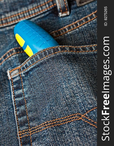 Blue denim jeans with a screw driver in the pocket