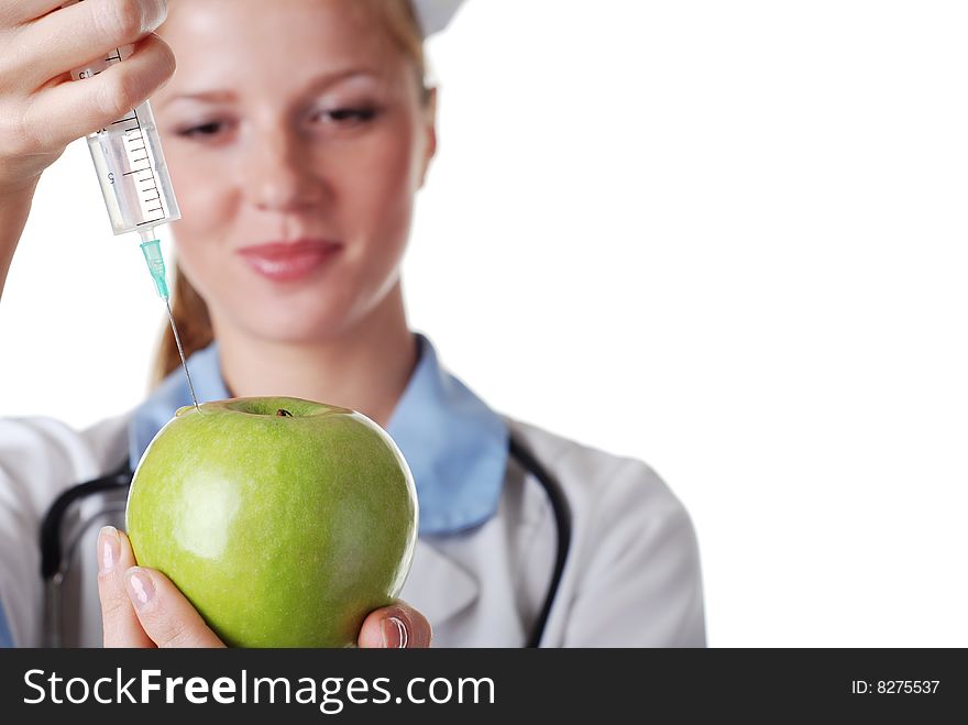 Nurse with syringe make injection in green apple