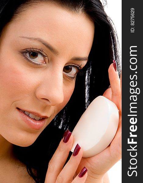 Top view of smiling young woman scrubbing her body against white background. Top view of smiling young woman scrubbing her body against white background