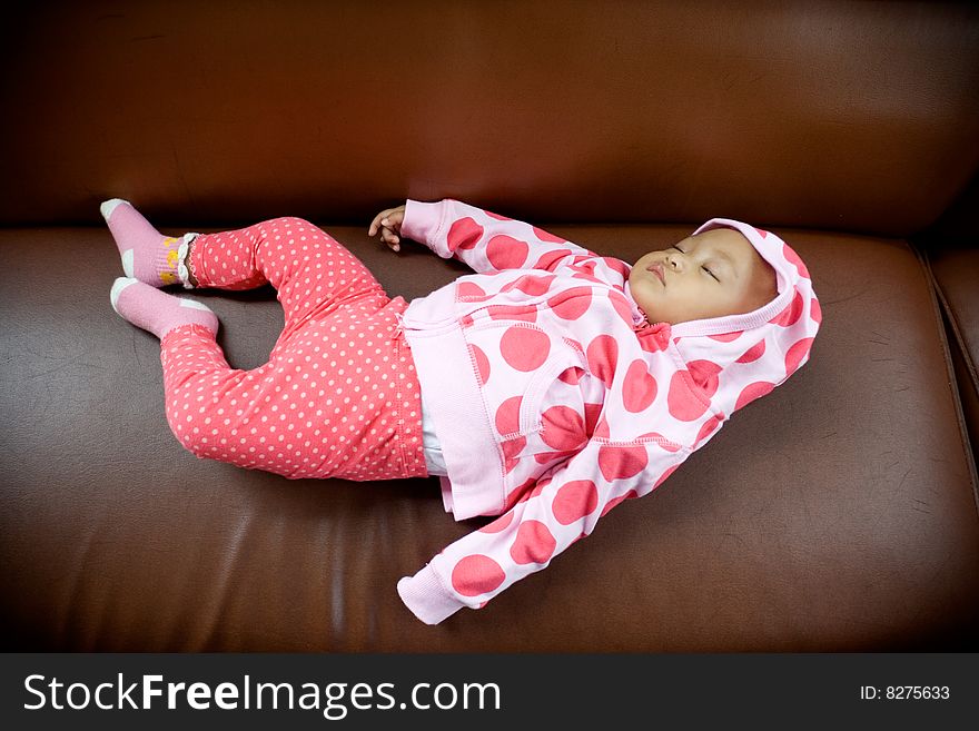 Photo of a baby fall a sleep on the sofa. Photo of a baby fall a sleep on the sofa