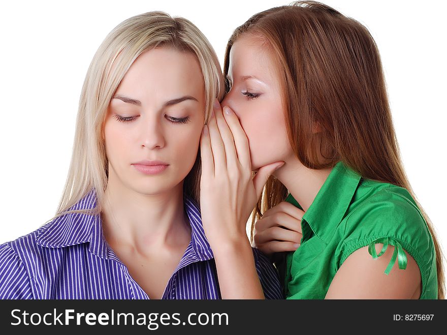 Two beautiful happy young friends are whispering