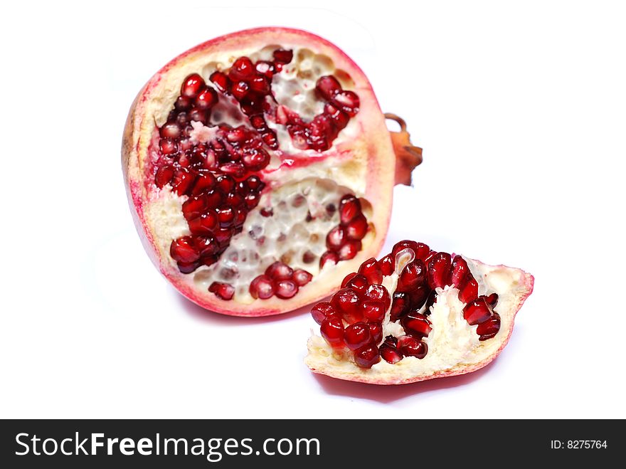 Slice of red sweet pomegranate on white background. Slice of red sweet pomegranate on white background
