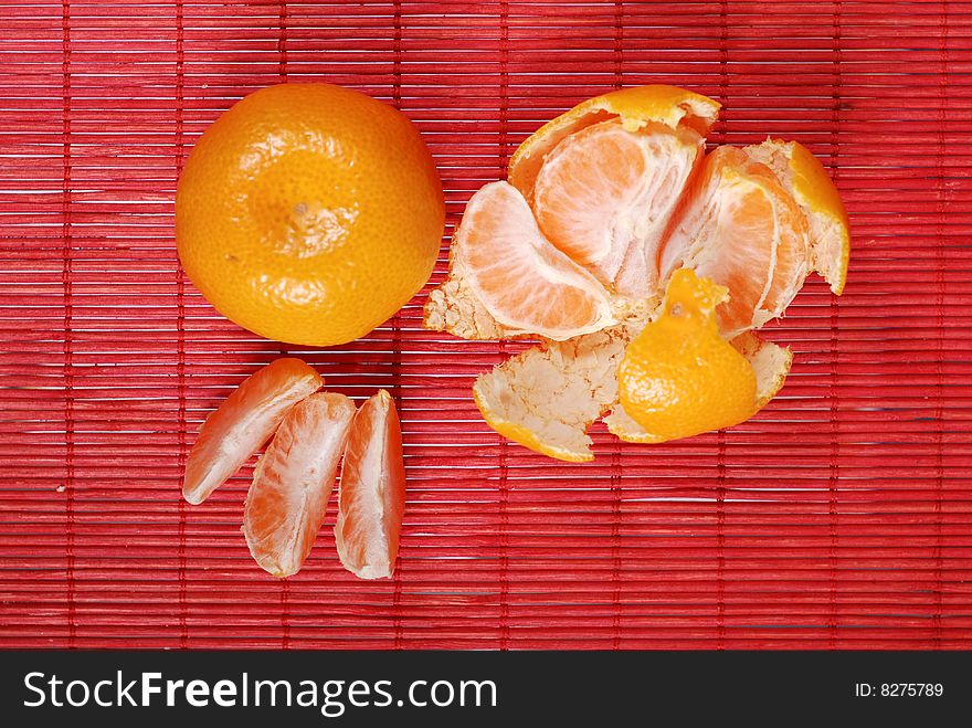 Juicy yellow and tangerines on red background