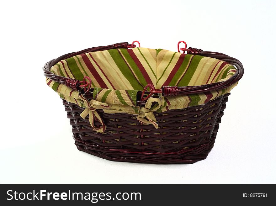 Cane basket with stripped cloth and handles isolated on white background. Cane basket with stripped cloth and handles isolated on white background