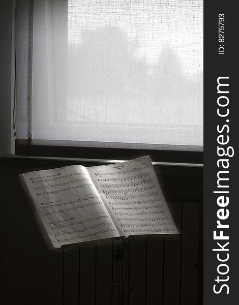 Musical score in front of the window. Musical score in front of the window