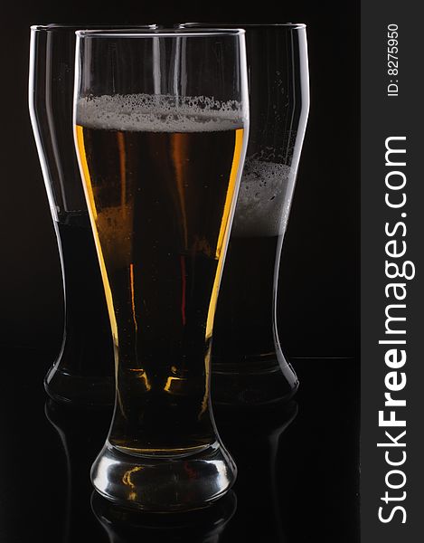 Three glasses with light and dark beer. Three glasses with light and dark beer
