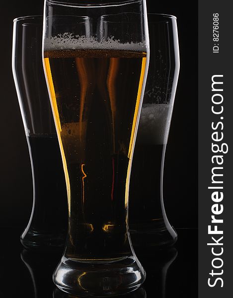 Three glasses with light and dark beer. Three glasses with light and dark beer