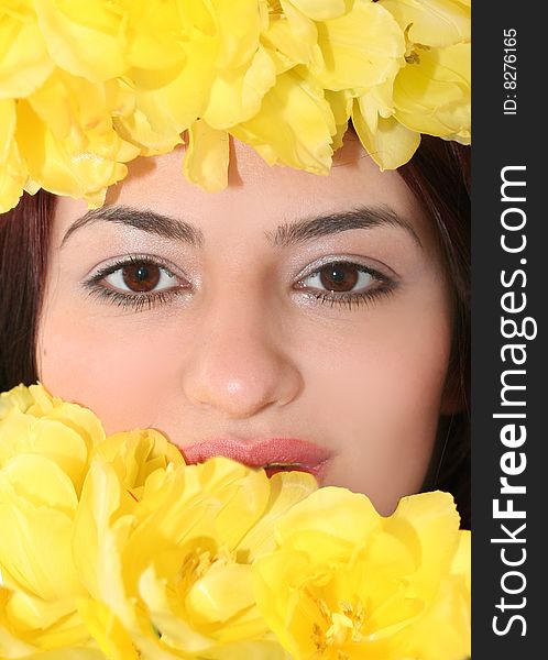 Oriental pretty girl with yellow tulips. Oriental pretty girl with yellow tulips