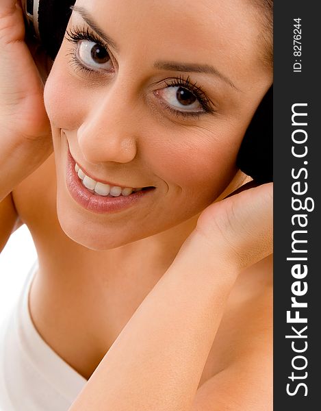 Top view of smiling woman enjoying music on white background