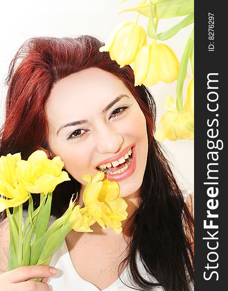 Oriental pretty girl with yellow tulips. Oriental pretty girl with yellow tulips