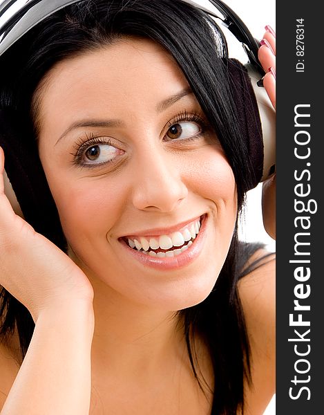 Close up of smiling young female enjoying music on an isolated background. Close up of smiling young female enjoying music on an isolated background