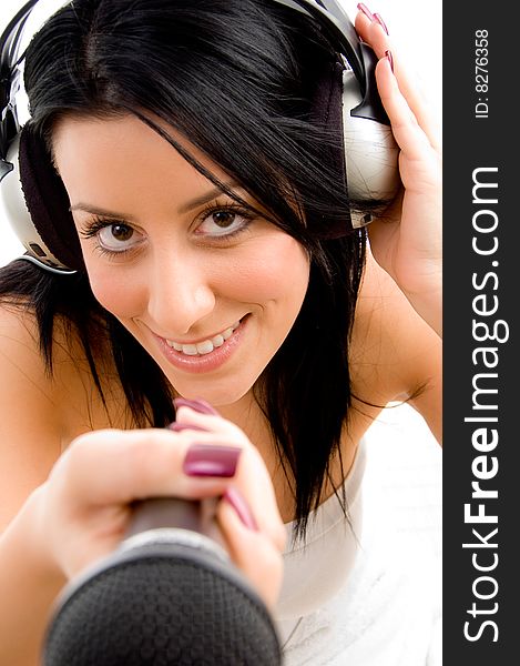 Top view of smiling female with headphone and microphone with white background