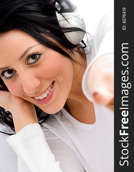 Top view of pointing young female enjoying music on an isolated white background. Top view of pointing young female enjoying music on an isolated white background