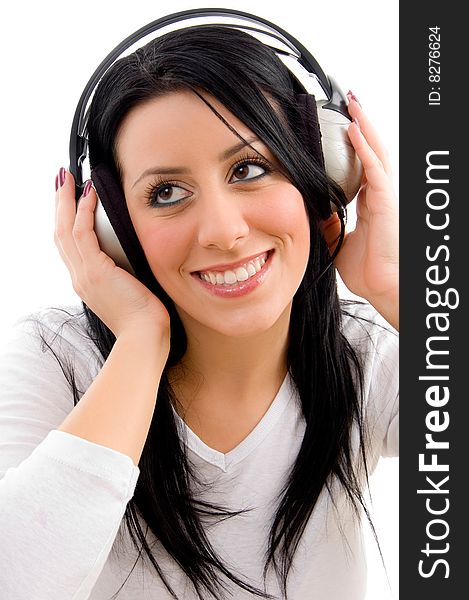 Front view of happy model listening music on an isolated background