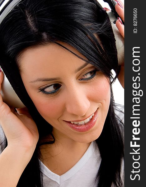 Close view of young model holding headphone