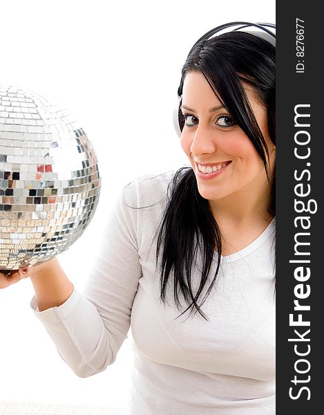 Half length view of female listening music and carrying disco ball on an isolated white background