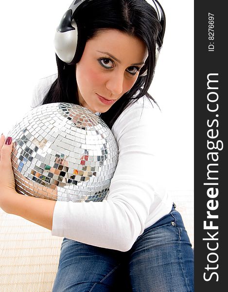 Close view of female listening music and holding disco ball with white background