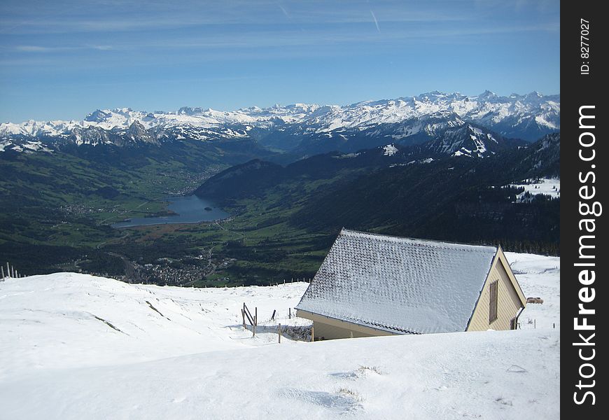 Snow coered house overlooking valley.