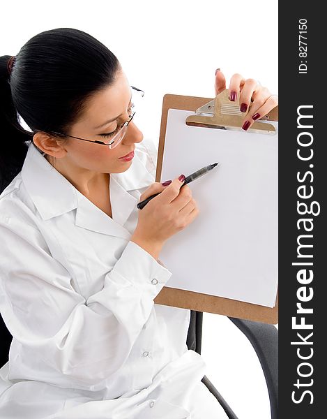 Side view of female doctor indicating writing pad with white background