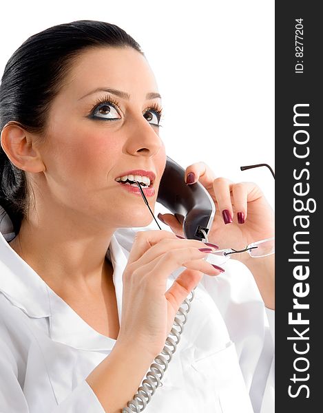 Side pose of doctor talking on phone and looking upward against white background