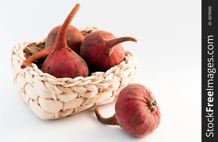 Still life of four fresh figs in a woven straw basket on white background. Still life of four fresh figs in a woven straw basket on white background