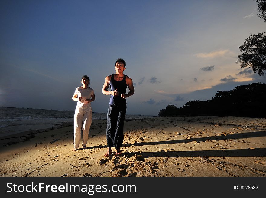 Couple Strolling On The Beach. Couple Strolling On The Beach