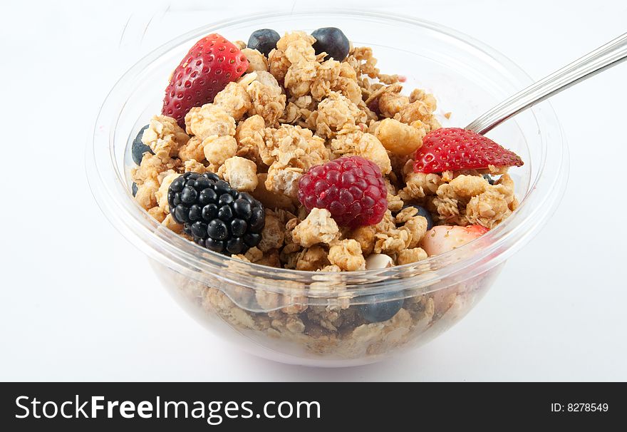 A bowl with yogurt, granola and fruits. A bowl with yogurt, granola and fruits.