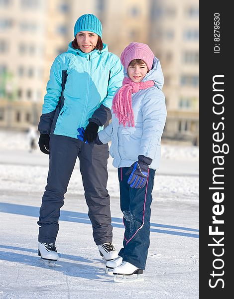 Mother with daughter at the skating rink.