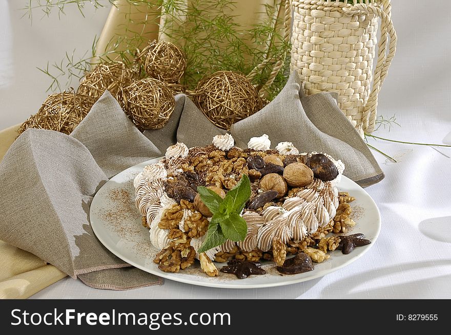 Cream cake, decorated the figured chocolate and walnut